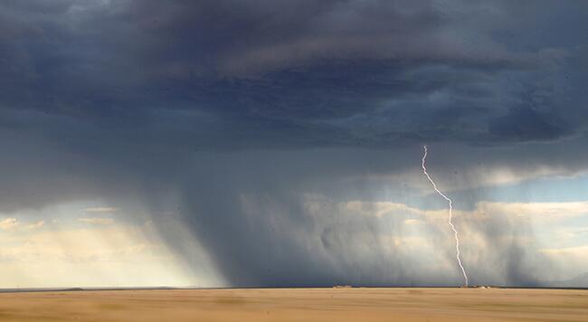 thunder and lightning storm rolling over farm land